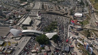 DCA08_054E - 4K stock footage aerial video orbit and fly over heavy border traffic to reveal the freeway at the US/Mexico Border, Tijuana