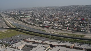 DCA08_059 - 4K aerial stock footage of the border fence and Rio Tijuana, US/Mexico Border, Tijuana