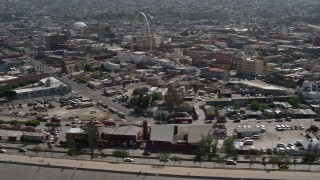 DCA08_061 - 4K aerial stock footage of a reverse view of urban homes, reveal Tijuana Arch, Tijuana, Mexico
