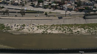 DCA08_062 - 4K aerial stock footage video of a canal by the border fence, Tijuana, Mexico