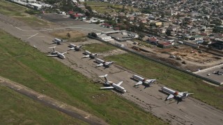 DCA08_067 - 4K aerial stock footage orbit commercial airplanes at Tijuana International Airport, Mexico