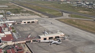 DCA08_068 - 4K aerial stock footage of terminals, passenger jets, and hangars at Tijuana International Airport, Mexico
