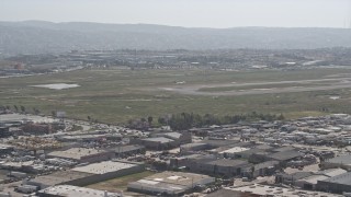 DCA08_071 - 4K aerial stock footage of a passenger jet coming in for a landing at Tijuana International Airport, Mexico