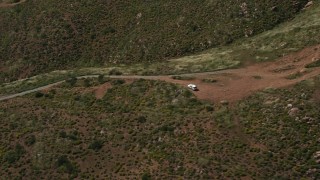 DCA08_075N - 4K aerial stock footage orbit Border Patrol truck on a green hill, US/Mexico Border, Tijuana