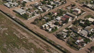 DCA08_078 - 4K aerial stock footage pass urban neighborhoods by border fence, US/Mexico Border, Tijuana