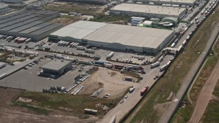 DCA08_079 - 4K aerial stock footage of warehouse buildings and big rigs, Tijuana, Mexico
