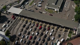 DCA08_090 - 4K aerial stock footage approach the US/Mexico Border at Otay Mesa and tilt to a bird's eye of cars, California