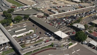 DCA08_091 - 4K aerial stock footage of a reverse view of the US/Mexico Border crossing in Otay Mesa, California