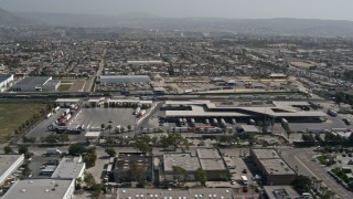 DCA08_093 - 4K aerial stock footage of flying by the US/Mexico Border checkpoint in Otay Mesa, California