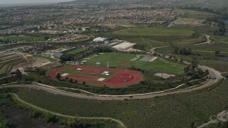 DCA08_112E - 4K aerial stock footage approach Olympic training fields, tilt to bird's eye view, Chula Vista, California