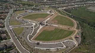 DCA08_120 - 4K aerial stock footage tilt from tract homes to reveal baseball fields at sports park, Chula Vista, California