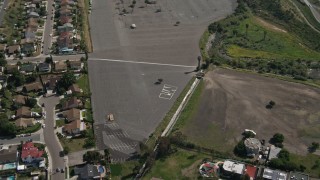 DCA08_124 - 4K aerial stock footage orbit parking lot suburban homes, Spring Valley, California