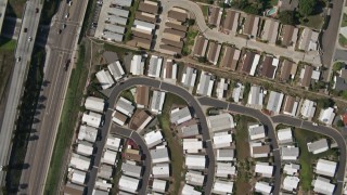 DCA08_127E - 4K aerial stock footage of a bird's eye view of tract homes, and reveal mobile homes, Spring Valley, California
