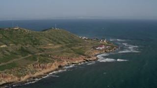 DCA08_166 - 4K aerial stock footage of coastal cliffs and lighthouse in Point Loma, California