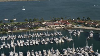 DCA08_176 - 4K aerial stock footage of a reverse view of an oceanside hotel and marina, Shelter Island, California