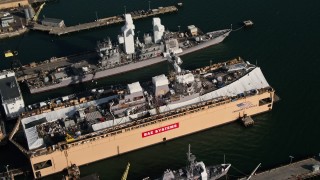 DCA08_187 - 4K aerial stock footage orbit naval warships under construction, San Diego, California