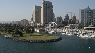 DCA08_194 - 4K aerial stock footage of low altitude flyby of waterfront hotels and marina, Downtown San Diego, California