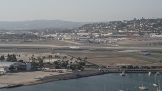 DCA08_198 - 4K aerial stock footage of tracking a landing passenger jet, San Diego International Airport, California