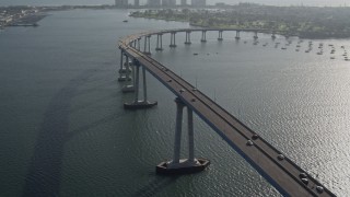 DCA08_203 - 4K stock footage aerial video of tracking cars crossing the Coronado Bridge, San Diego, California