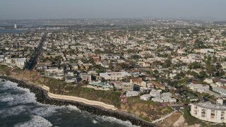 DCA08_228 - 4K aerial stock footage of coastal neighborhoods by low cliffs, Point Loma, California