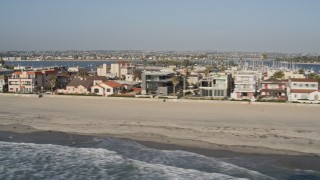 DCA08_233 - 4K aerial stock footage of flying by beachfront condominiums, Mission Beach, California