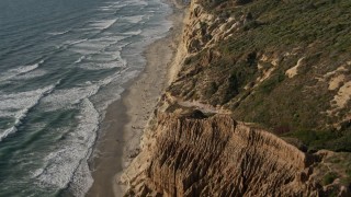 DCA08_257E - 4K aerial stock footage of panning across coastal cliffs and beach, La Jolla, California