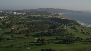 DCA08_259E - 4K aerial stock footage fly over coastal cliffs to reveal a golf course, La Jolla, California