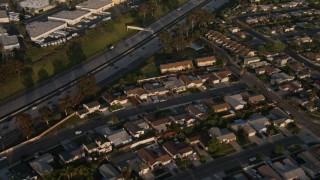 DCA08_270 - 4K aerial stock footage fly away from freeway and tract homes, Clairemont Mesa East, California, Sunset