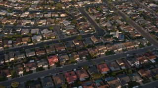 DCA08_271 - 4K aerial stock footage of a reverse view of tract homes in the suburbs, Clairemont Mesa East, California, Sunset