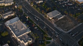 DCA08_272 - 4K aerial stock footage of a reverse view of strip malls, and reveal suburban houses, Clairemont, California, Sunset