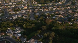 DCA08_273 - 4K aerial stock footage of a reverse view of suburban tract homes in Clairemont, California, Sunset