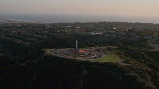 DCA08_276 - 4K aerial stock footage orbit Soledad Cross monument, La Jolla, California, Sunset