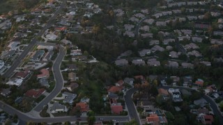 DCA08_282 - 4K aerial stock footage of a reverse view of tract homes and reveal park, La Jolla, California, Sunset