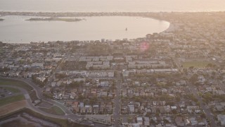 DCA08_286 - 4K aerial stock footage of bayside suburban houses and park, Pacific Beach, California, Sunset