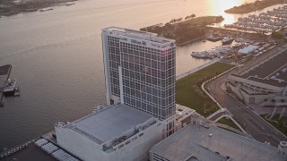 DCA08_299 - 4K aerial stock footage video of a bayside hotel in Downtown San Diego, California, at sunset