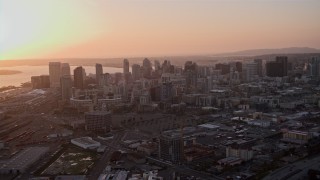 DCA08_301 - 4K aerial stock footage approach skyscrapers in Downtown San Diego, California, Sunset