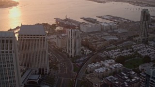 DCA08_303 - 4K aerial stock footage of flying over downtown skyscrapers to luxury hotel and marina in Downtown San Diego, California, Sunset