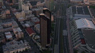 DCA08_309 - 4K aerial stock footage of a condominium skyscraper complex in Downtown San Diego, California, Sunset