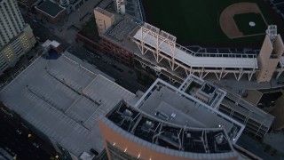 DCA08_312 - 4K aerial stock footage of a bird's eye view of city streets, and reveal a baseball stadium, Downtown San Diego, California, Sunset
