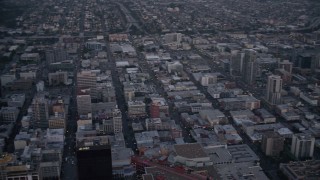 DCA08_324 - 4K aerial stock footage pan across city skyscrapers, tilt to reveal streets, mall, and park in Downtown San Diego, California, Sunset