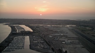 DCA08_327 - 4K aerial stock footage of the setting sun over San Diego International Airport, California