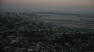 DCA08_330E - 4K aerial stock footage of Downtown San Diego and San Diego International Airport, California, twilight