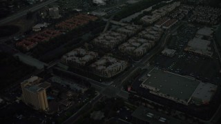 DCA08_335 - 4K aerial stock footage fly away from apartment buildings and reveal a freeway, Mission Valley, California, twilight