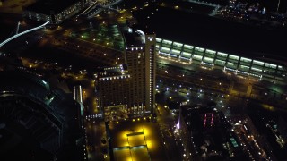 DCA08_350 - 4K aerial stock footage fly over luxury hotels at night in Downtown San Diego, California, and tilt to reveal Coronado