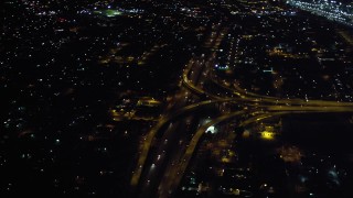 DCA08_351 - 4K aerial stock footage of tilt from freeway to reveal interchange at night in Downtown San Diego, California