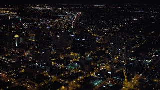 DCA08_352 - 4K aerial stock footage of panning from sports stadium to skyscrapers in Downtown San Diego, California, Night