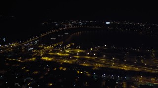 DCA08_358 - 4K stock footage aerial video of panning across the Coronado Bridge, the bay, and Coronado, California at night
