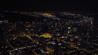 DCA08_359 - 4K aerial stock footage of tilting from city buildings to skyscrapers, Downtown San Diego, California, Night