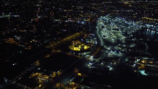 DCA08_365 - 4K aerial stock footage approach Port of San Diego and pan to Logan Heights suburban houses in California, Night