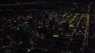 DCA08_375E - 4K aerial stock footage video of panning from luxury hotels to approach skyscrapers at night in Downtown San Diego, California